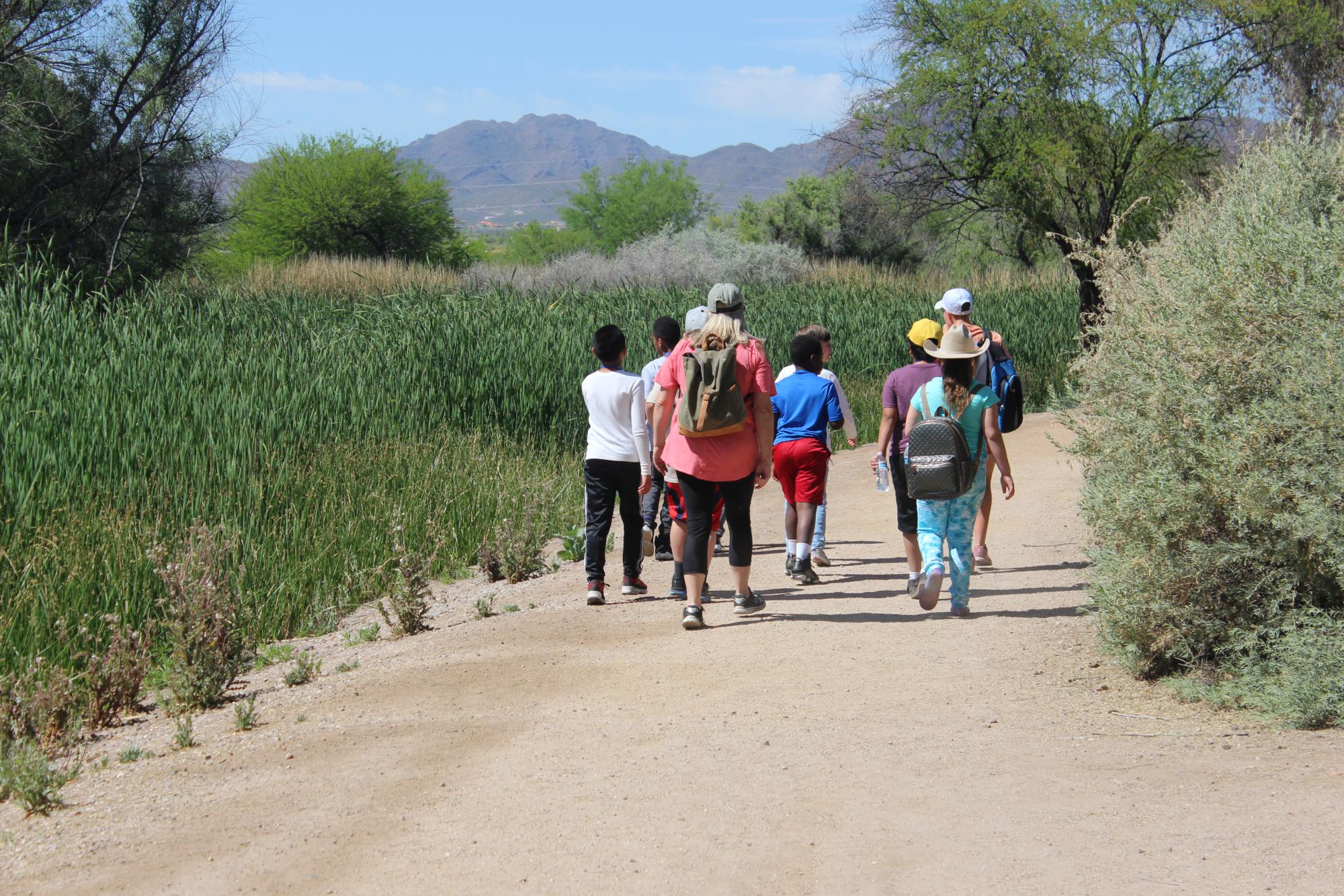 Photo of Arizona Project WET Tucson Water Educators leading students on an outdoor field trip in Sweetwater Wetlands