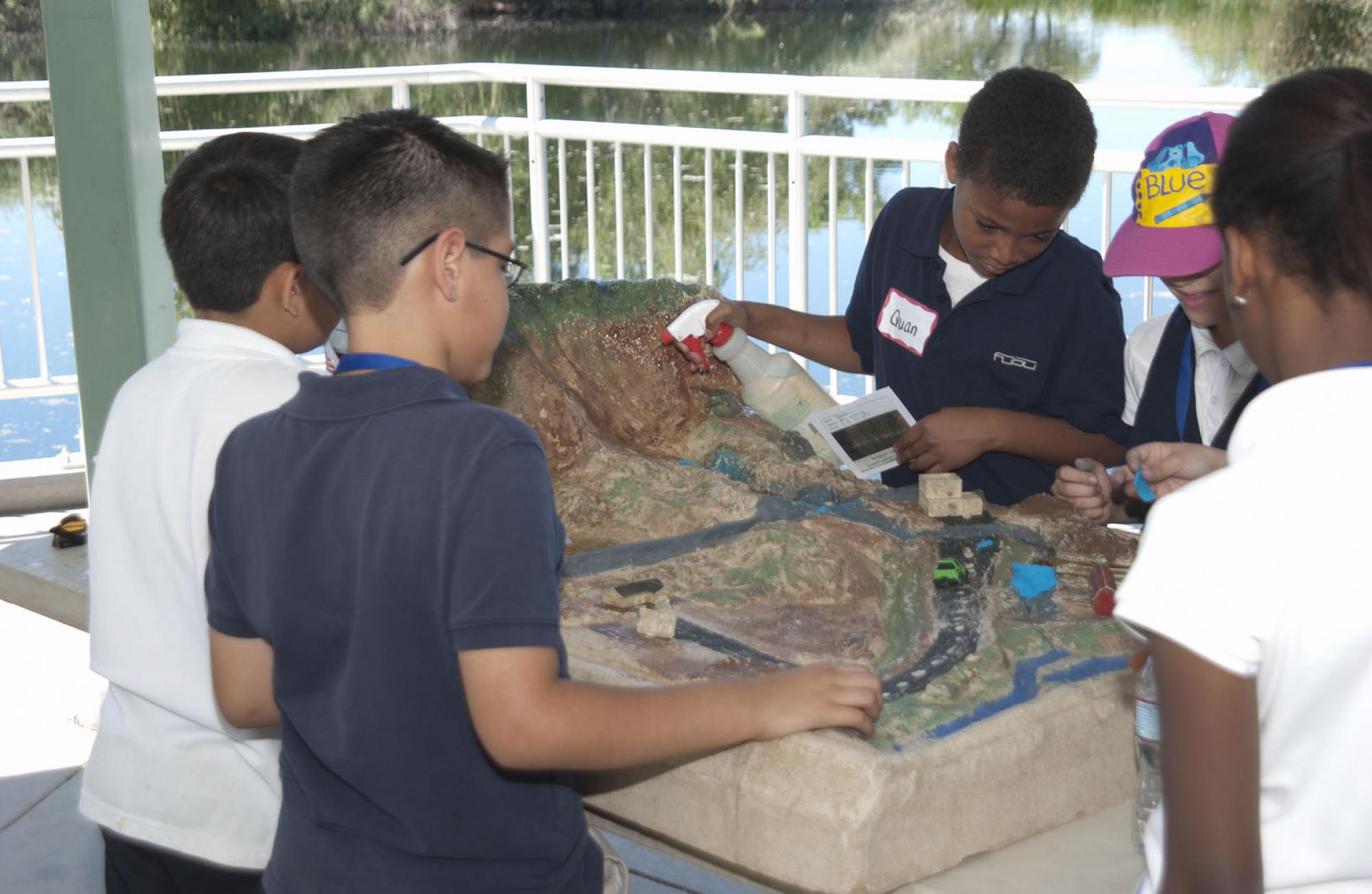 Photo of Students Looking at Watershed Station at Sweetwater Wetlands